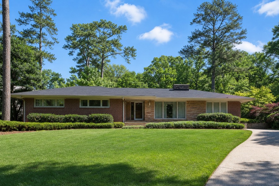 A handsome mid-century modern brick ranch house in Collier Heights at golden hour.